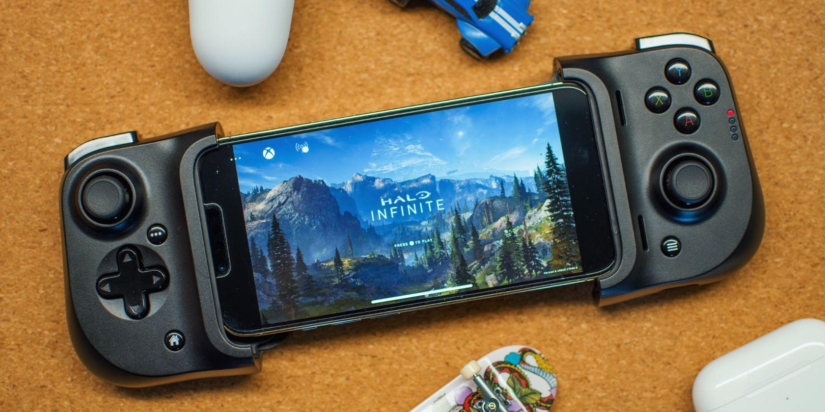 Orang yang memainkan game lewat ponsel dengan pengontrol seluler